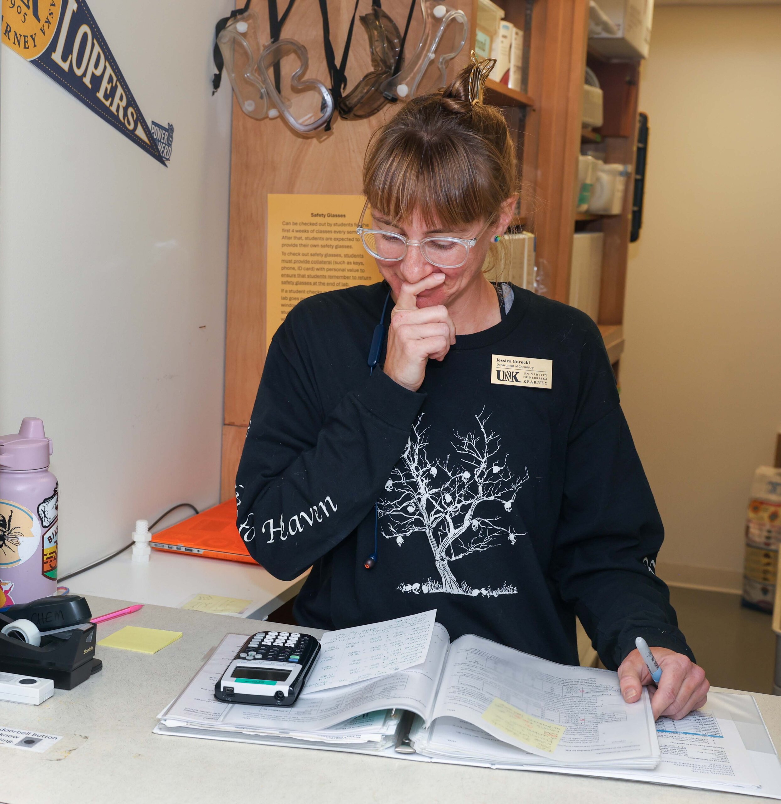 A woman reads over material.