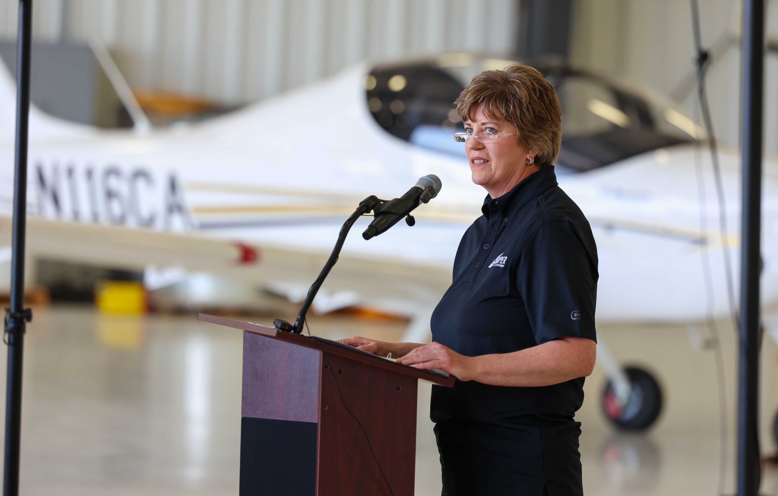 UNK College of Business and Technology Dean Brooke Envick speaks Thursday during the Loper Flight Academy ribbon-cutting ceremony.