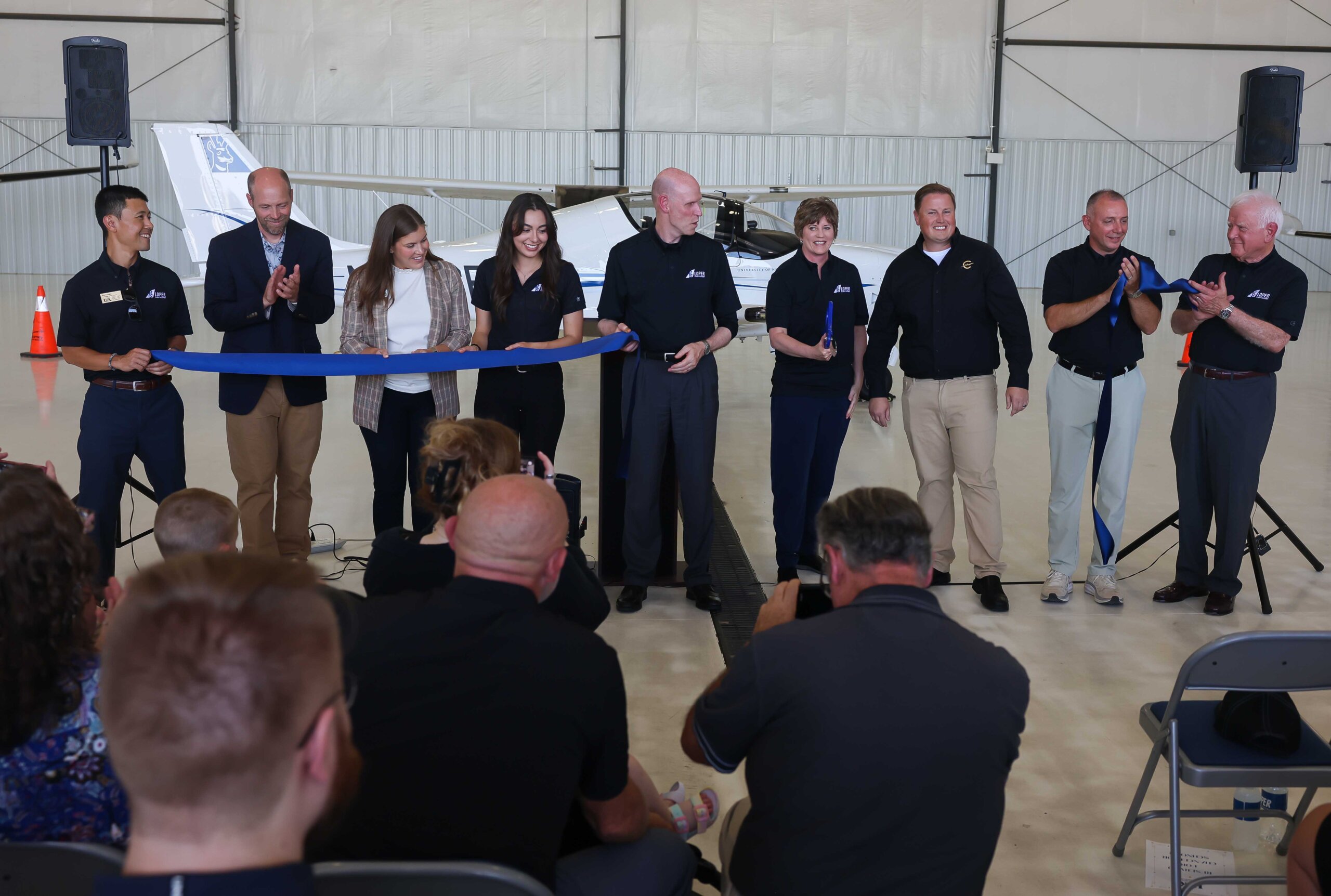 The ribbon is cut during Thursday's celebration at Kearney Regional Airport, officially launching the new Loper Flight Academy.