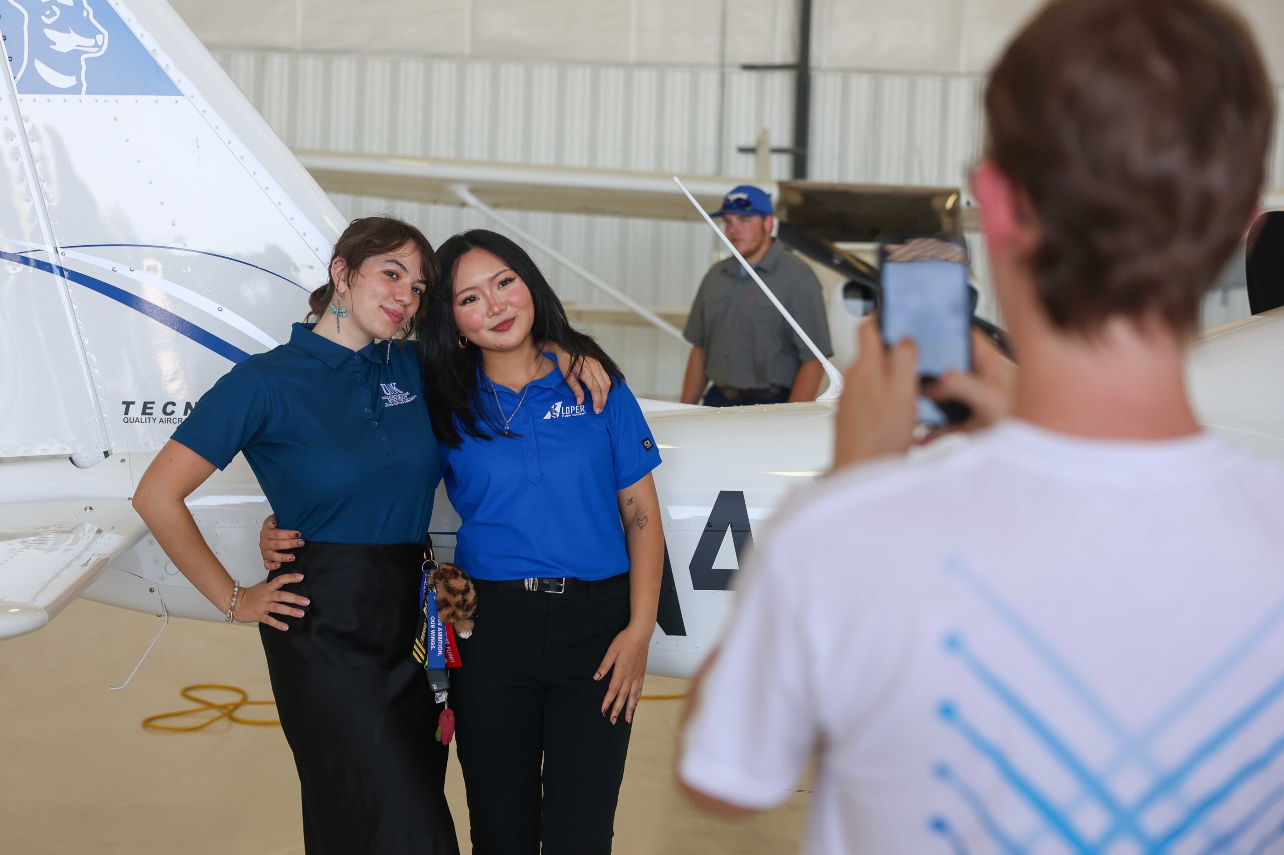 Attendees pose for a photo during the Loper Flight Academy ribbon-cutting ceremony.