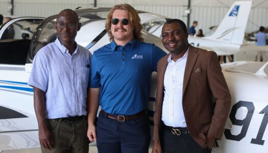 Attendees pose for a photo during the Loper Flight Academy ribbon-cutting ceremony.
