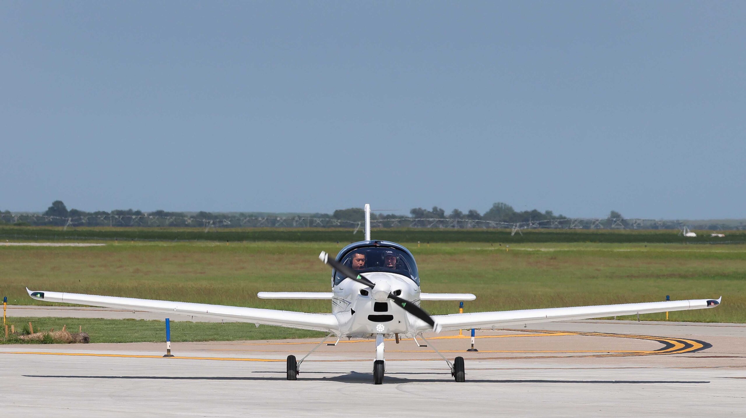 UNK Chancellor Neal Schnoor and assistant chief flight instructor Masahiro Suzuki land one of the Tecnam planes at Kearney Regional Airport during Thursday's ribbon-cutting ceremony celebrating the new Loper Flight Academy.