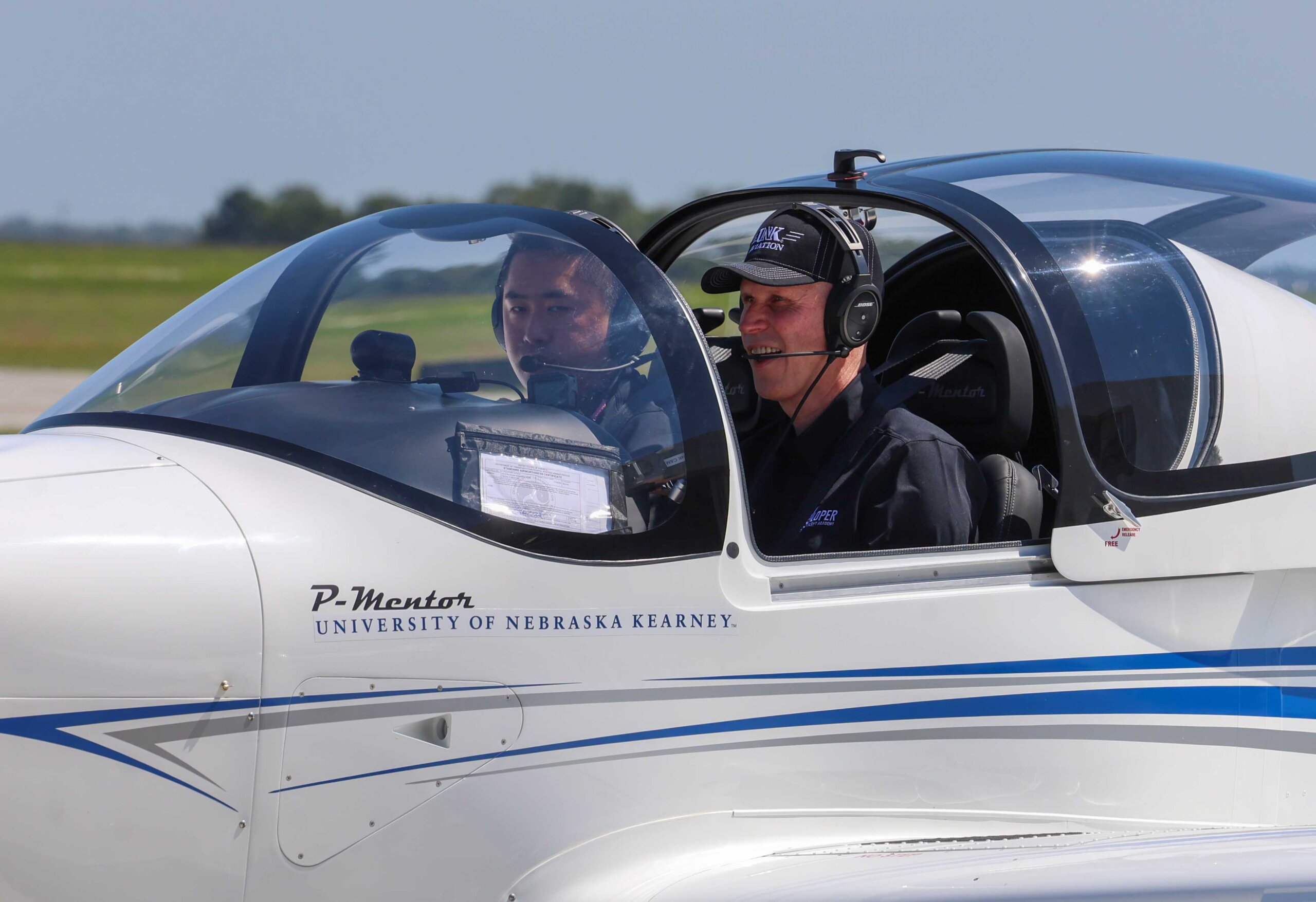 UNK Chancellor Neal Schnoor and assistant chief flight instructor Masahiro Suzuki land one of the Tecnam planes at Kearney Regional Airport during Thursday's ribbon-cutting ceremony celebrating the new Loper Flight Academy.