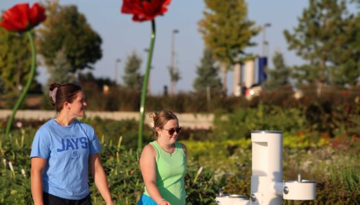 UNK students walk in Yanney Park.