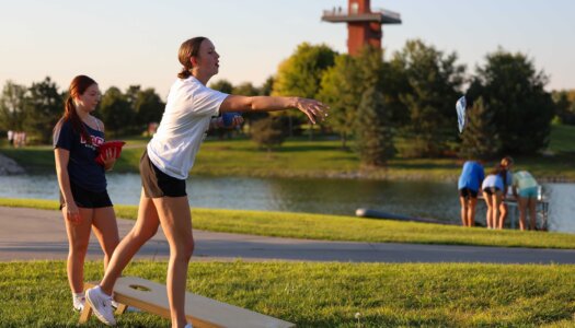 UNK students play cornhole at Yanney Park.