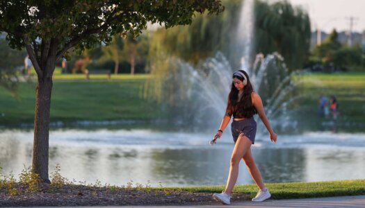 A UNK student walks in Yanney Park.