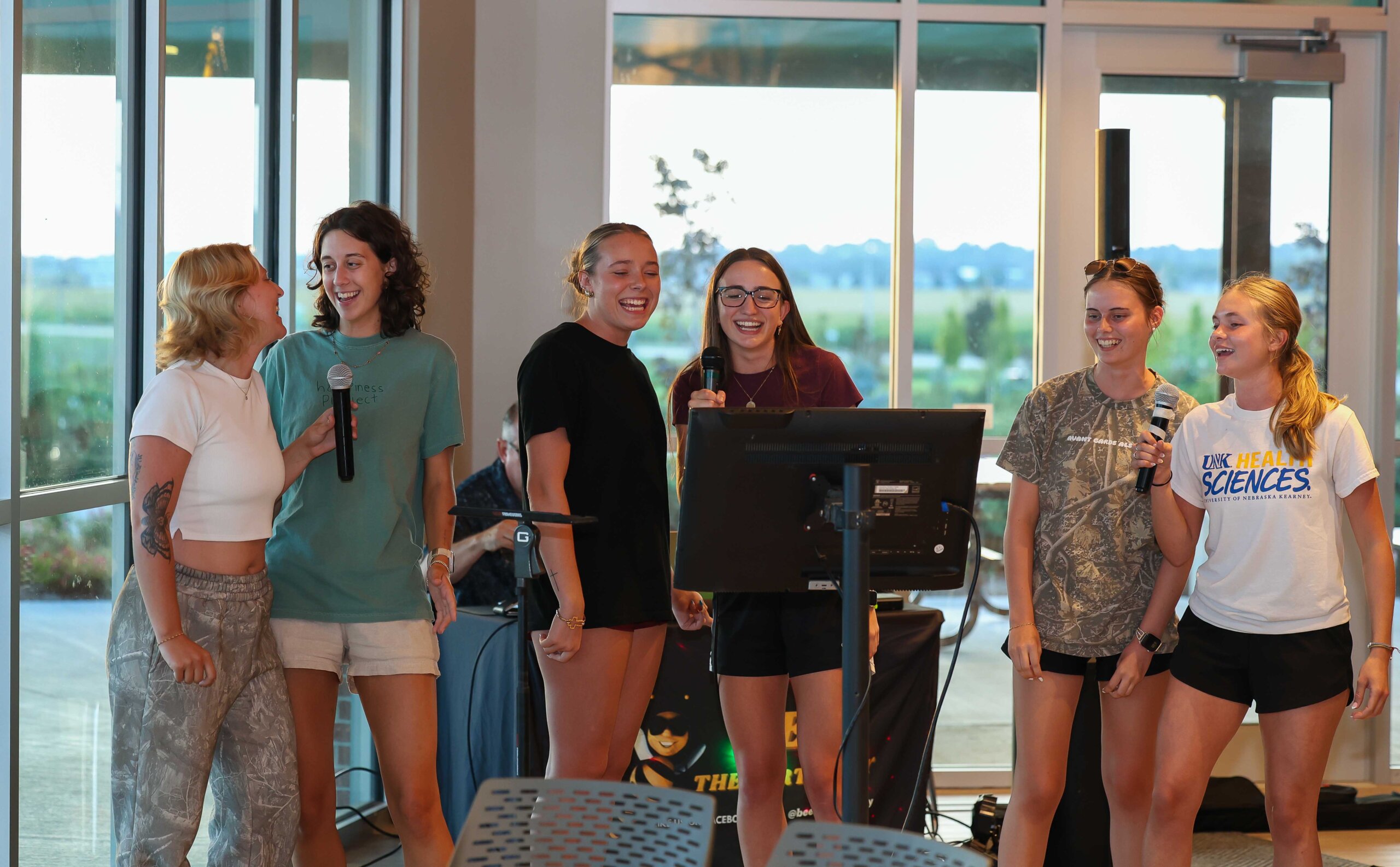 UNK students sing karaoke during the Loper Lot Party.