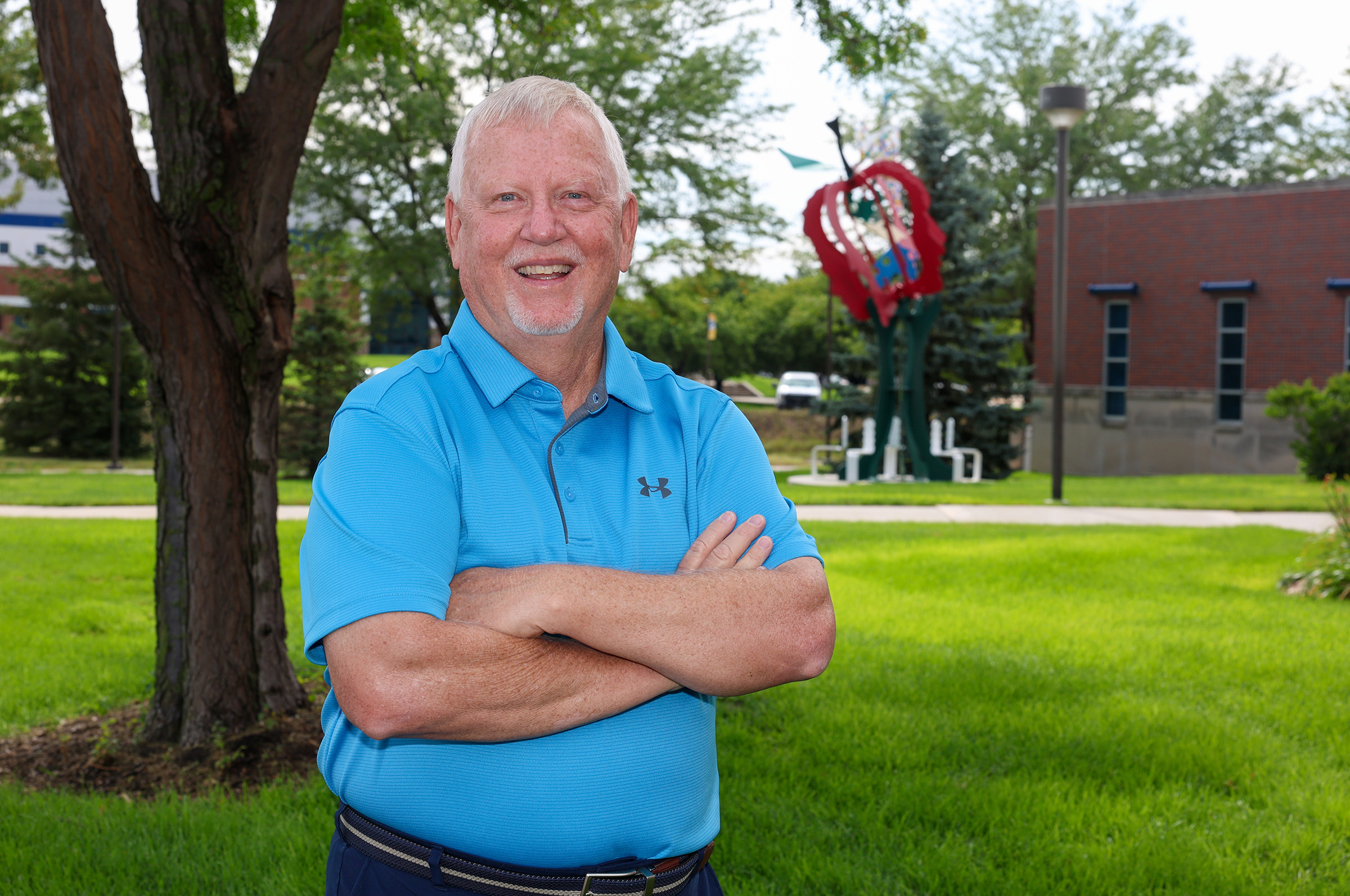 Mike Teahon poses for a photo outside the UNK College of Education.