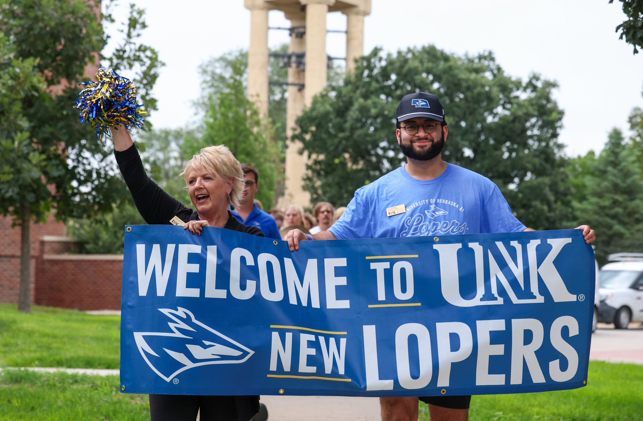 Staff hold a welcome sign.