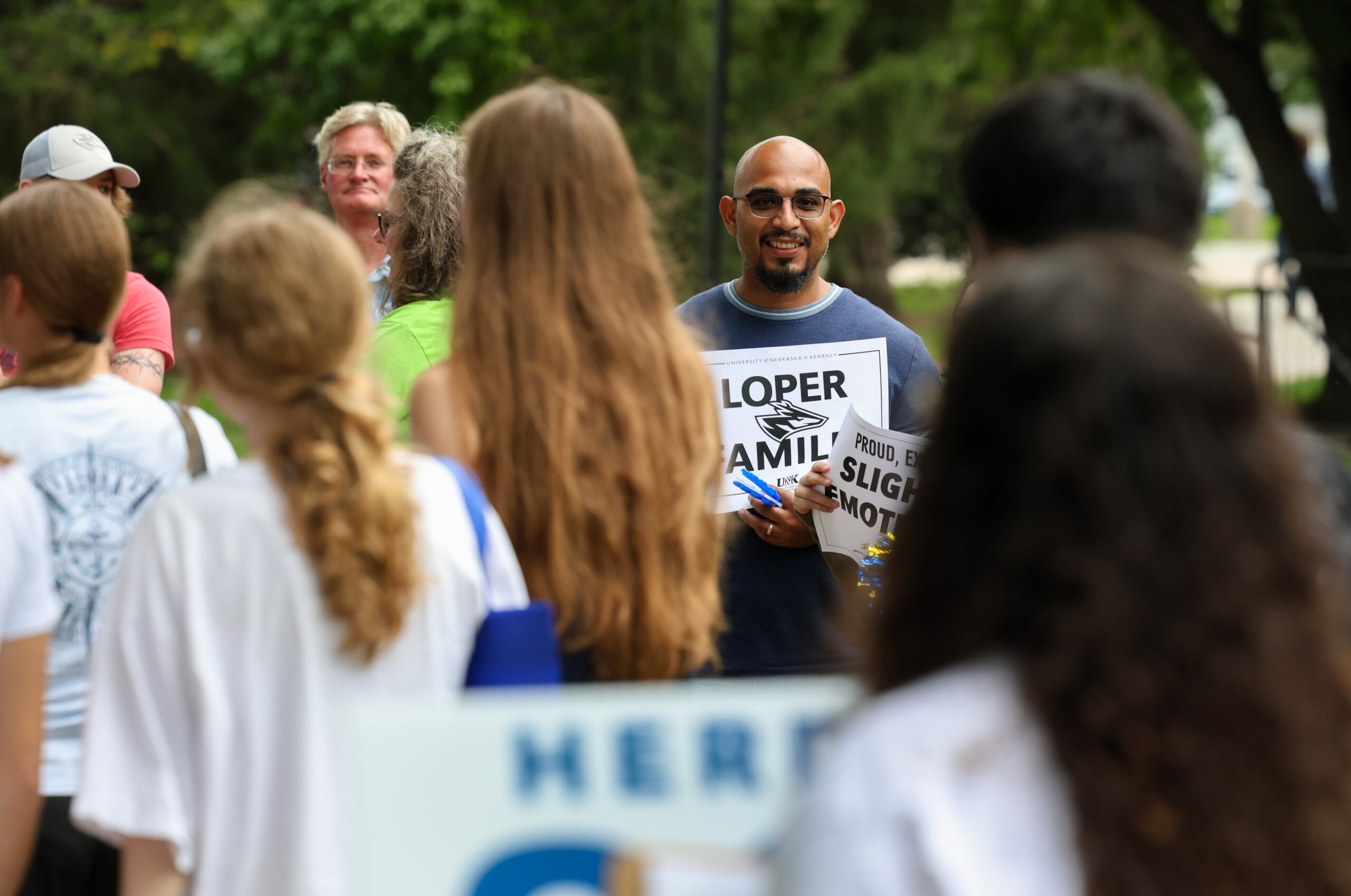 Family cheer on new students.