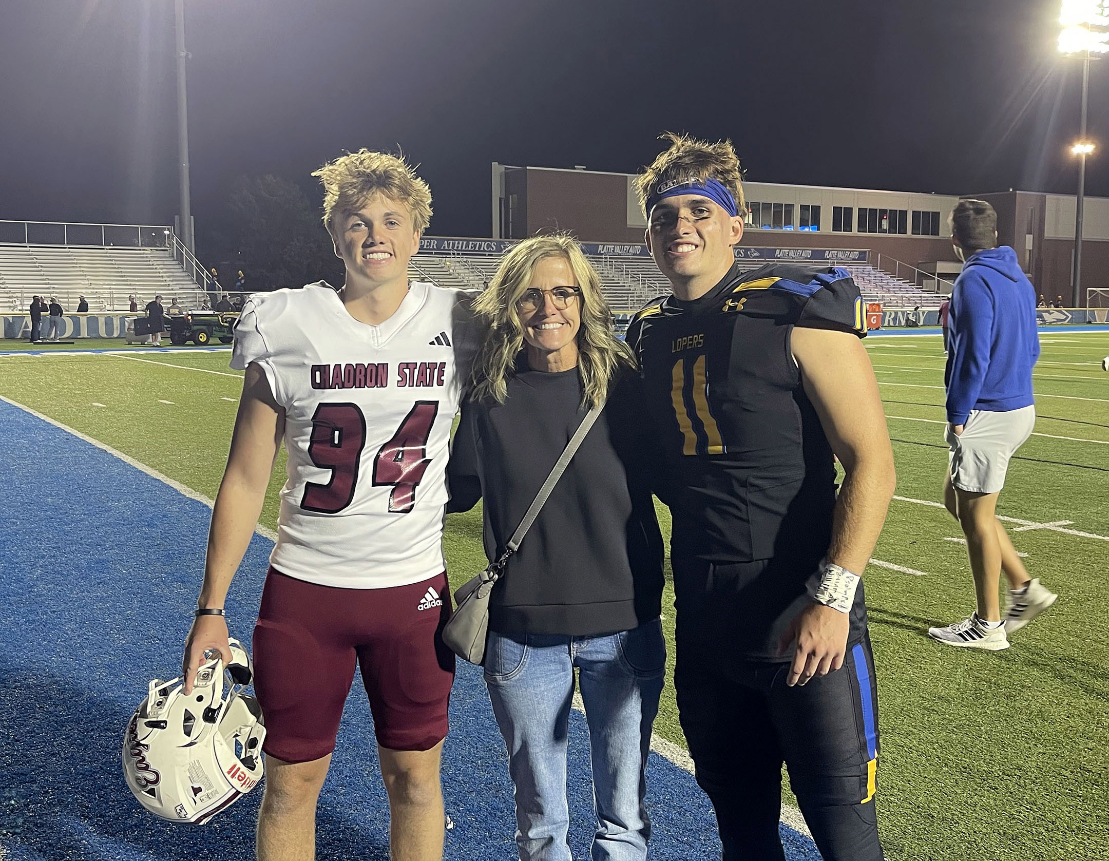 Shay and Trey Prichard are pictured with their mother Nicole after last year’s UNK-Chadron State football game in Kearney.