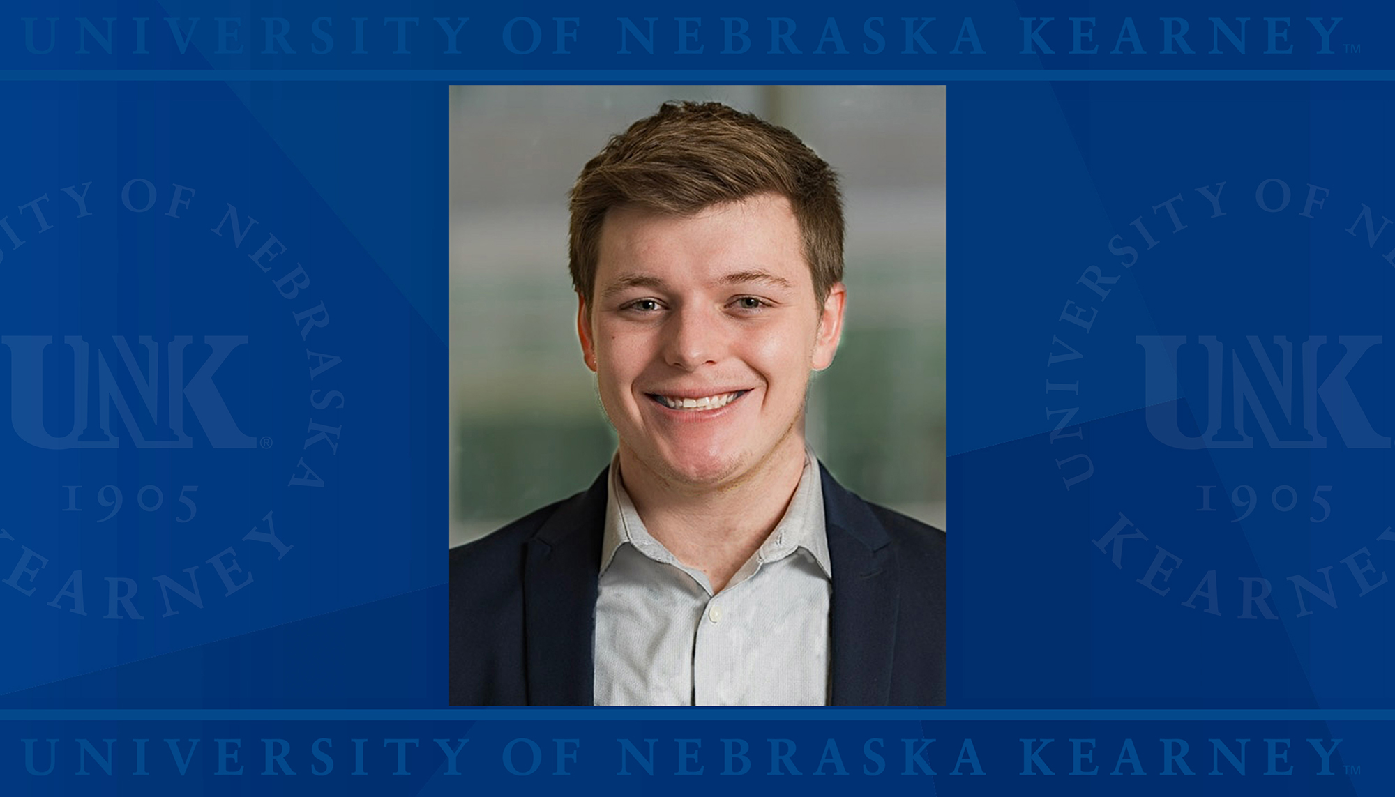 Samuel Buss headshot over UNK logo