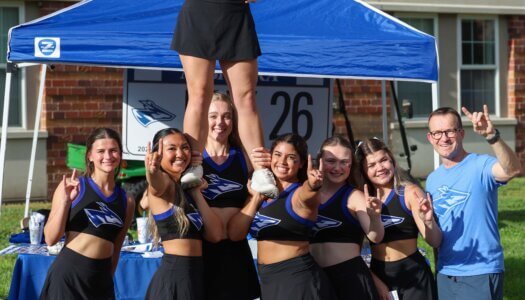 UNK Cheer does a stunt at Blue Gold Showcase.
