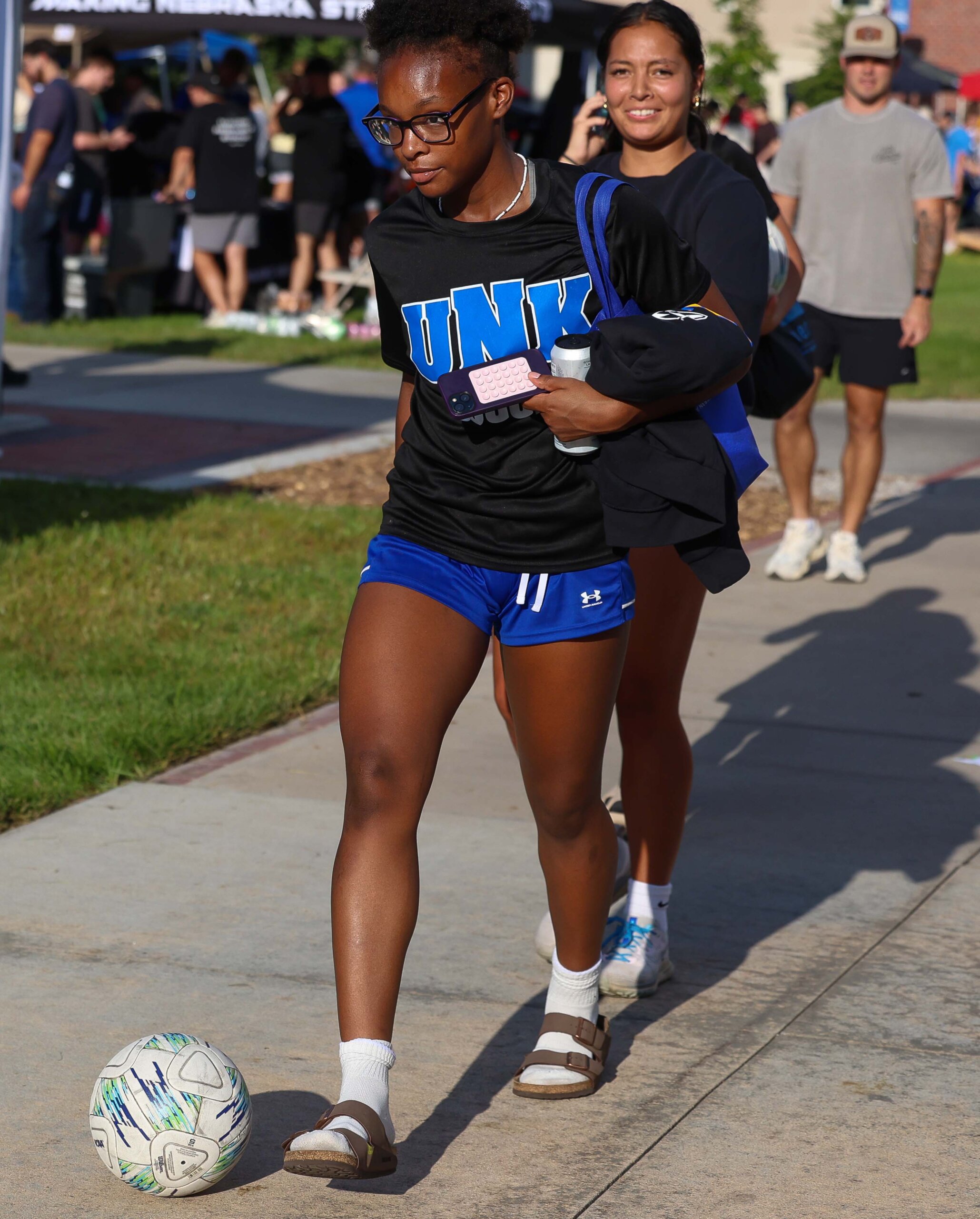 A soccer player dribbles a ball.
