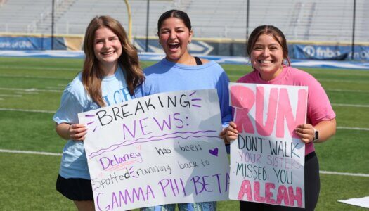 UNK sorority members pose with their signs.