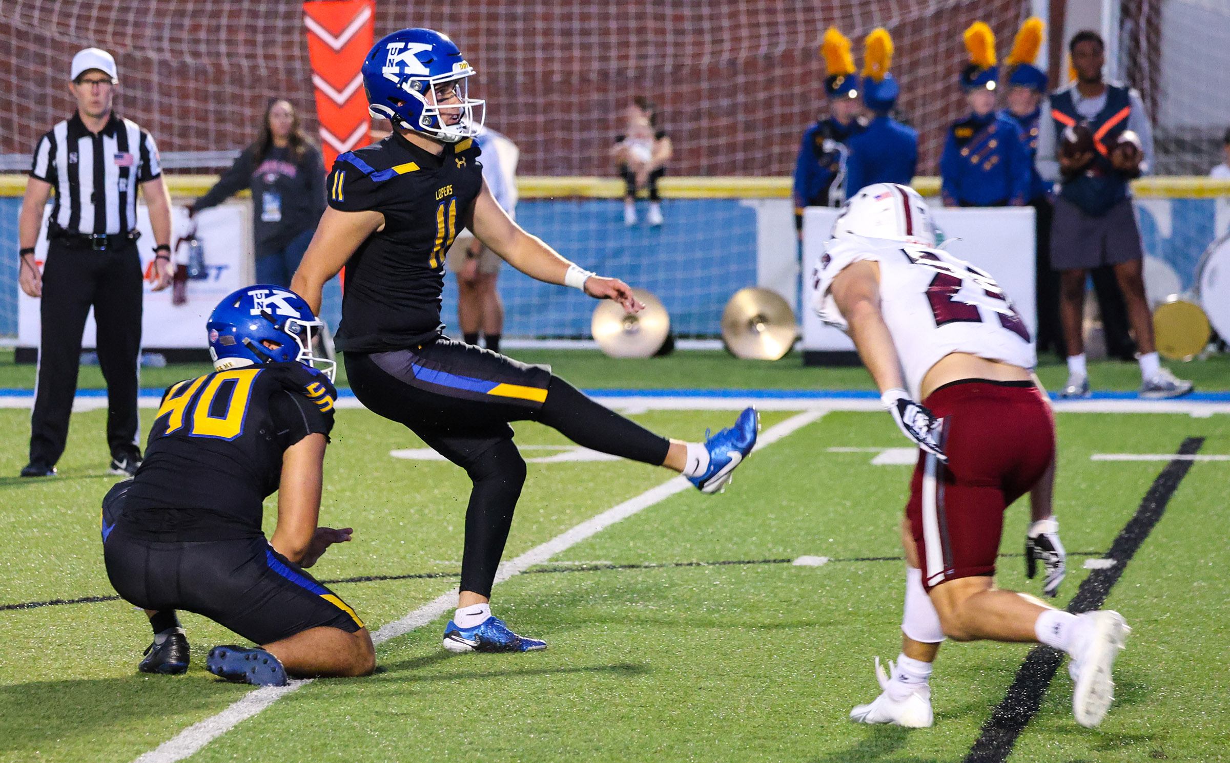 Trey Prichard (11) makes a kick for UNK during last year’s game against Chadron State at Cope Stadium in Kearney.