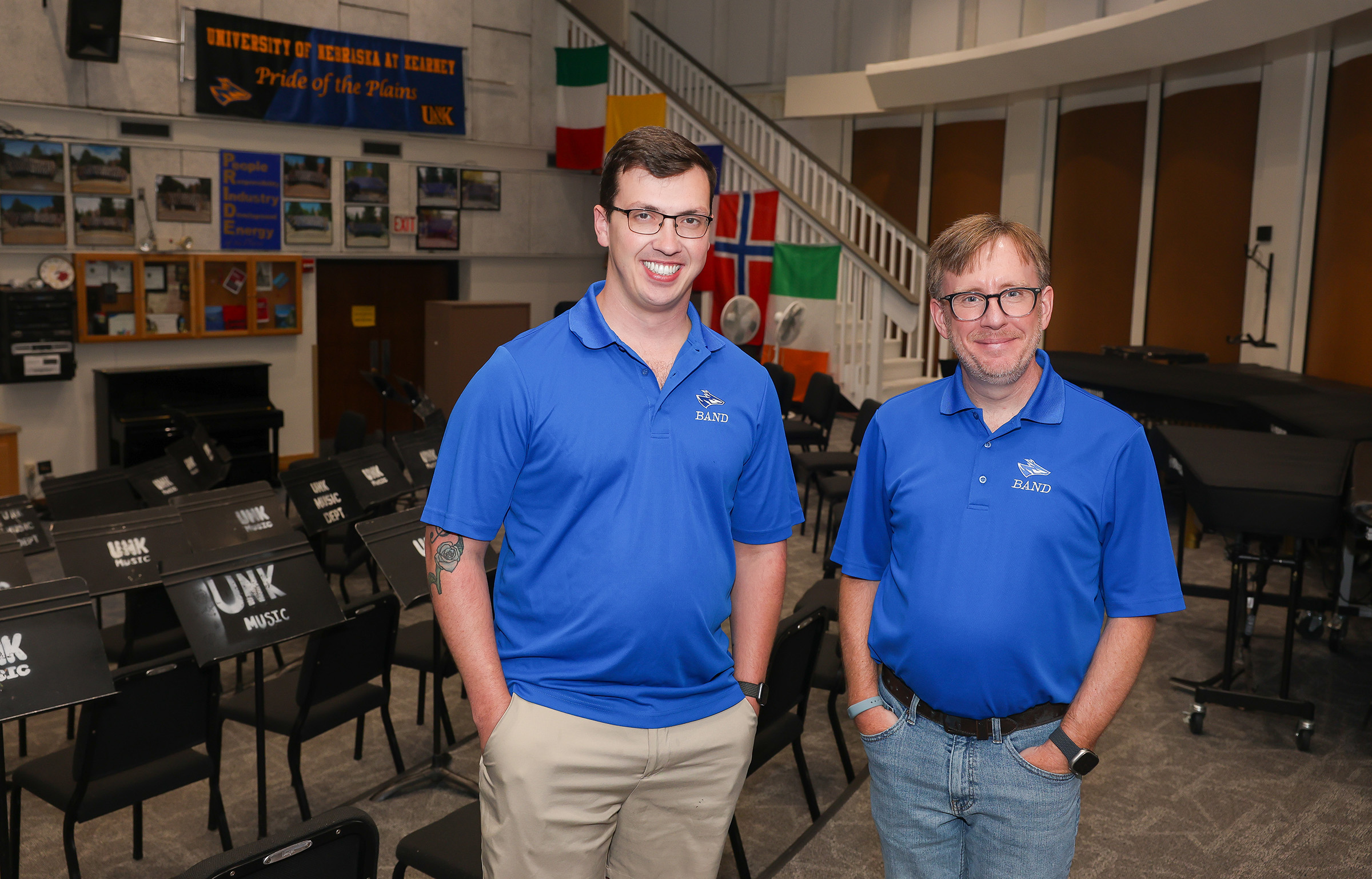 Tyler Hawk and Brian Alber pose for a photo in the UNK band room.