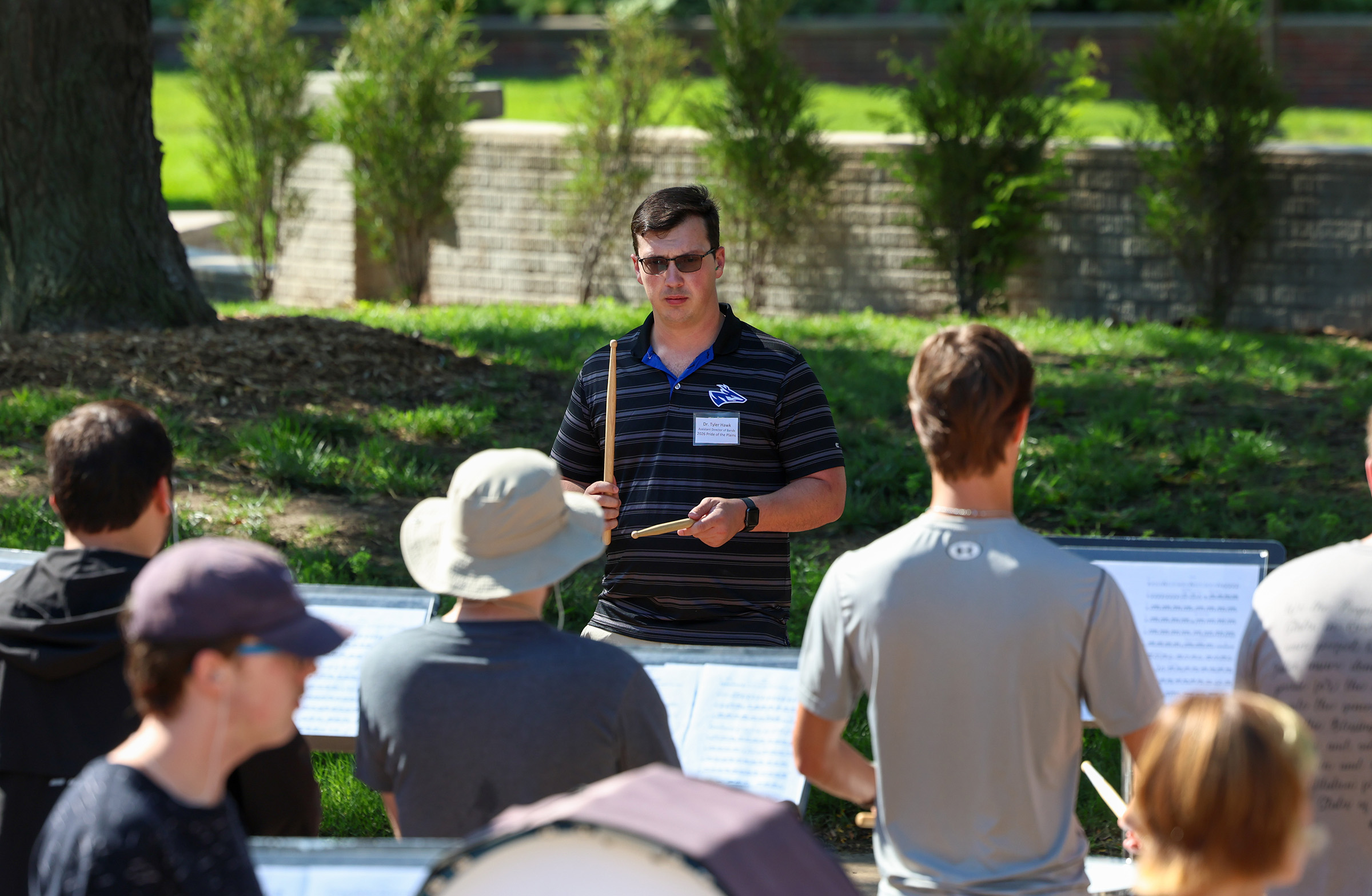 Tyler Hawk, the new assistant director of bands at UNK, works with percussion students during marching band camp earlier this month.