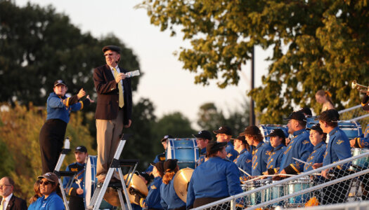 Brian Alber directs the Pride of the Plains Marching Band.