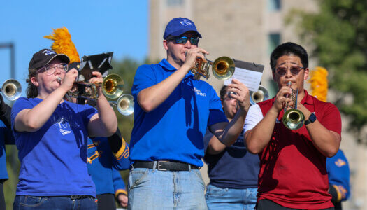 UNK alumni perform with the Pride of the Plains Marching Band during homecoming.
