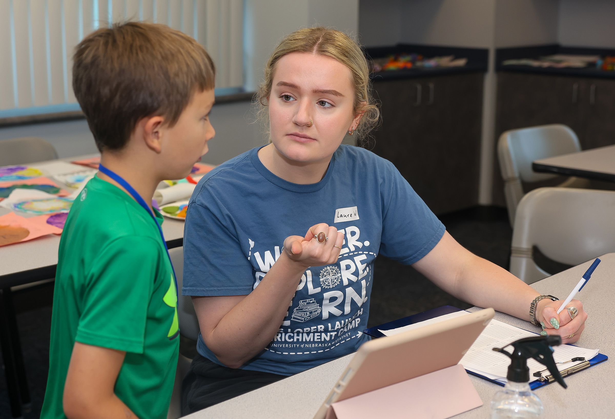 Laura Walsh works with a student during the Loper Launch Speech Academy.