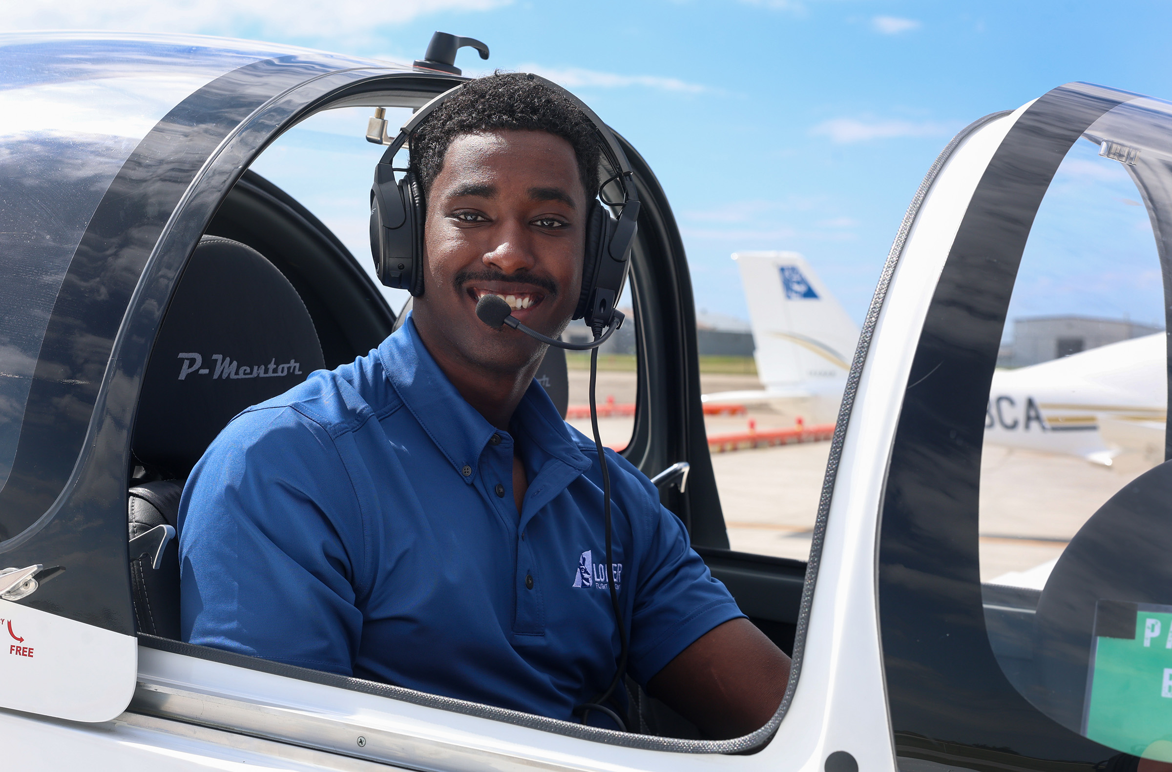Fila Yusuf is pictured inside a plane at the Loper Flight Academy.