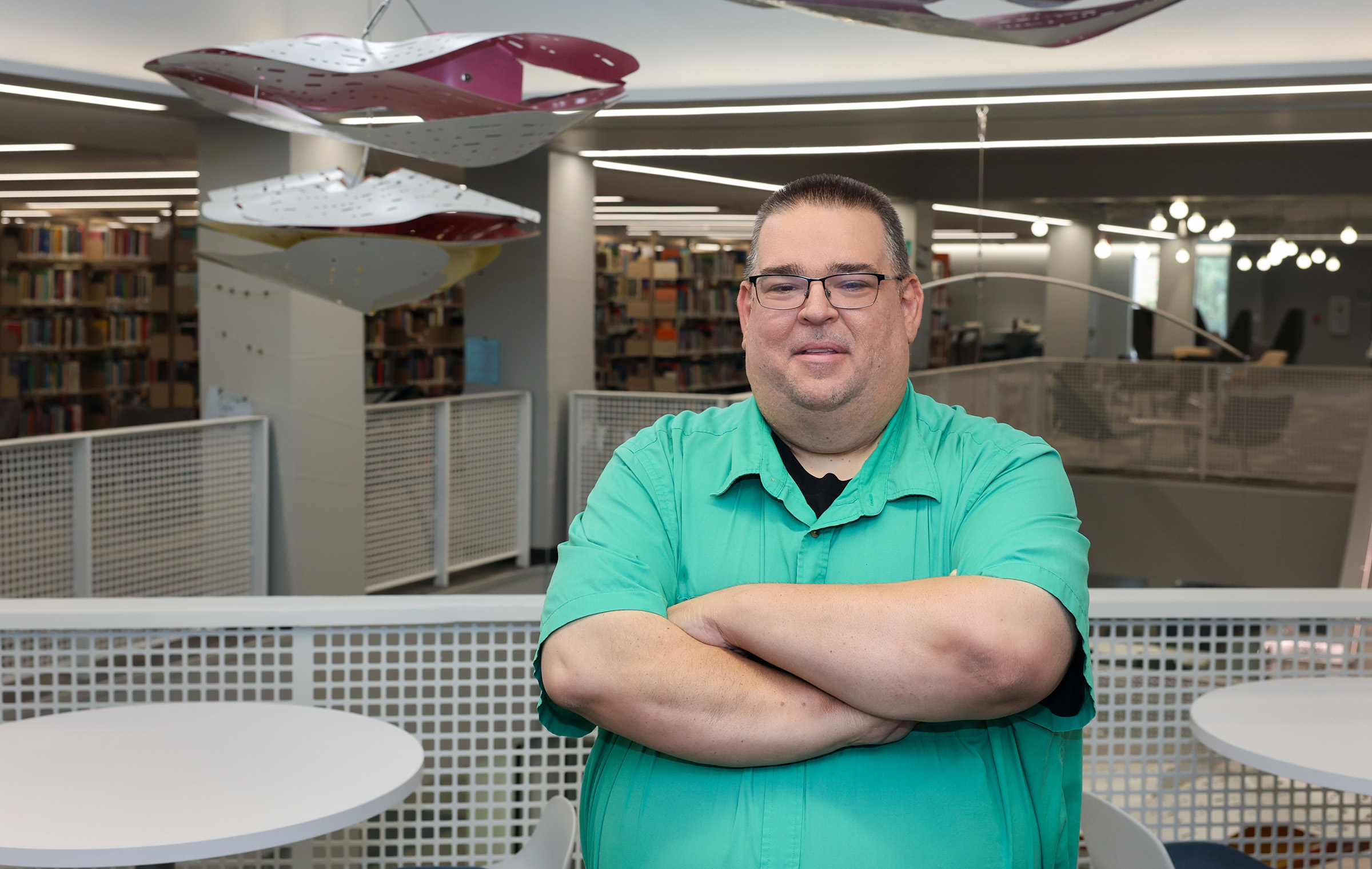 Jim Fields poses for a photo inside the UNK library.