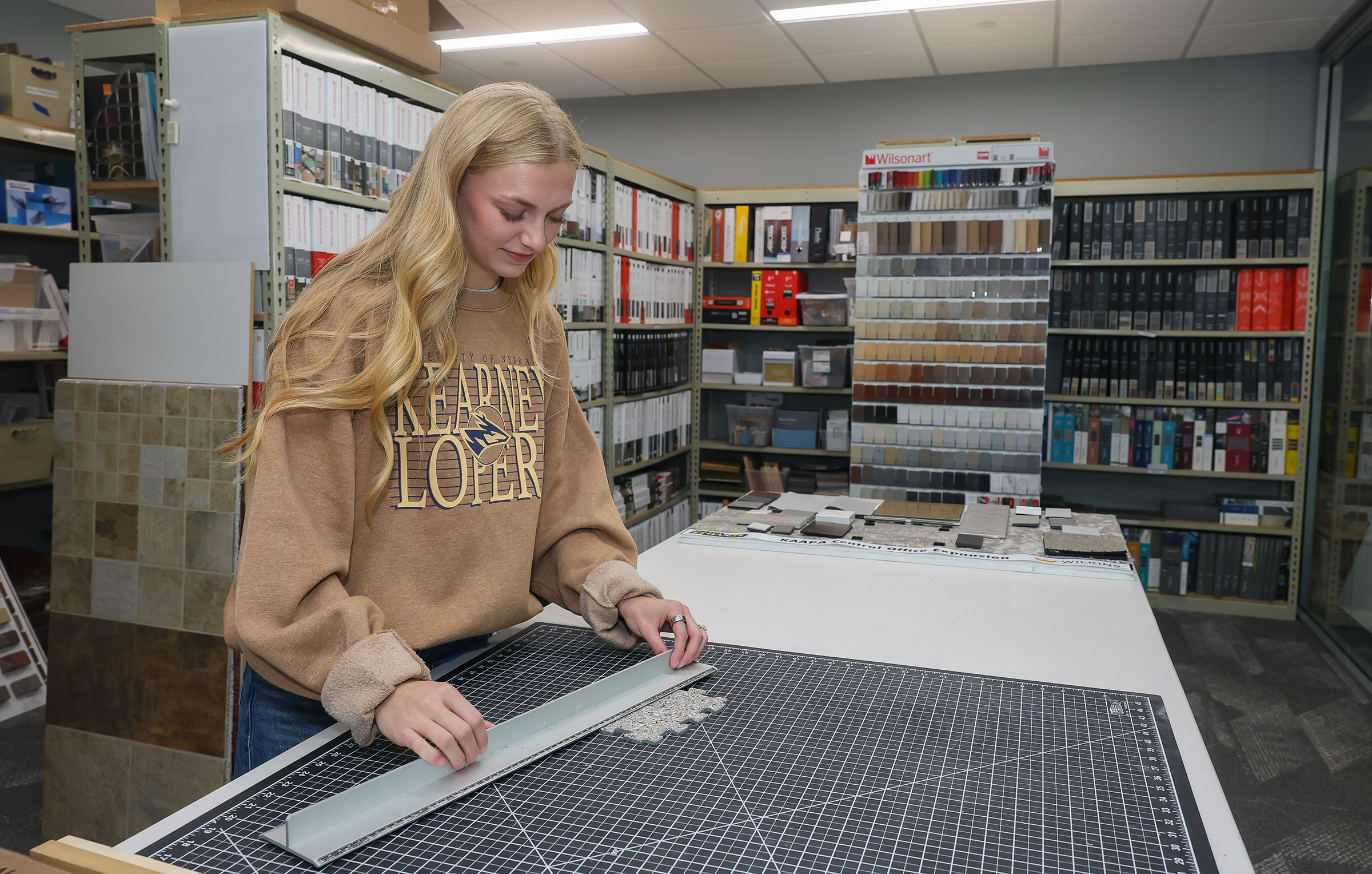 Joee Lempke looks at tile samples at Wilkins ADP.