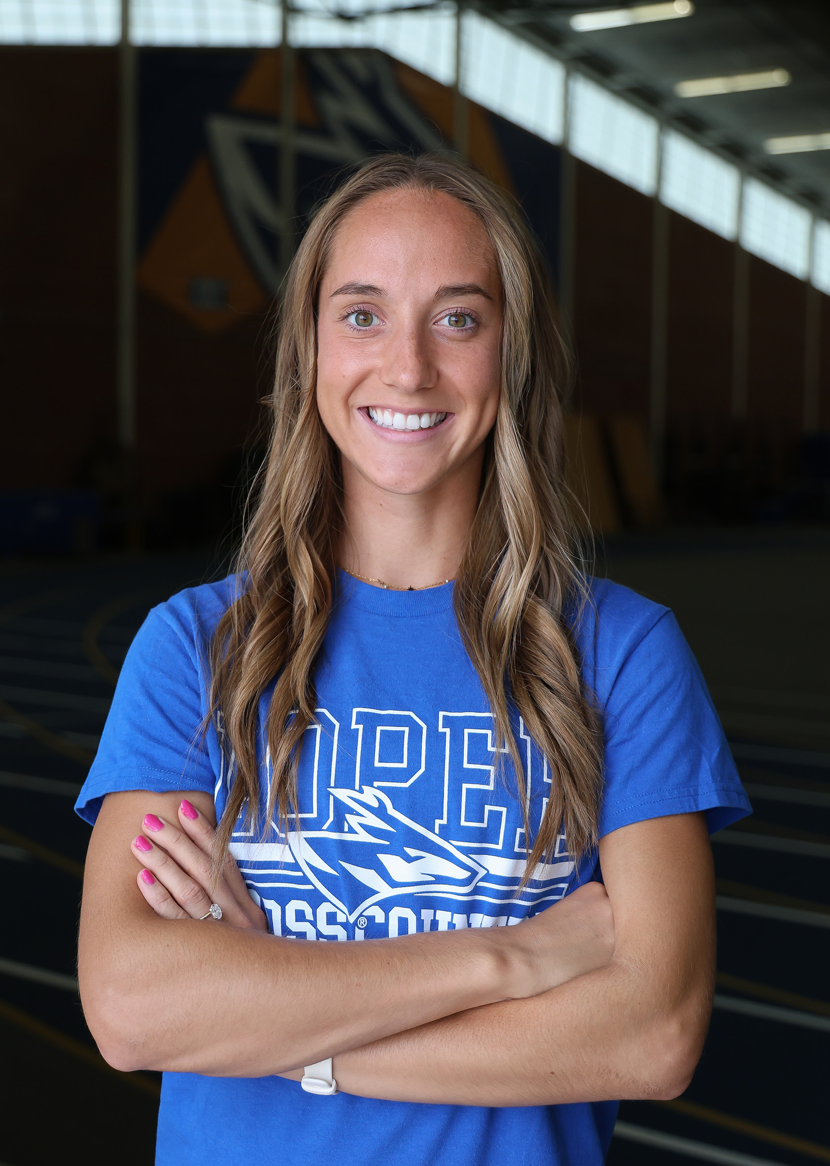 Kassidy Stuckey poses for a photo in UNK's Cushing Coliseum.