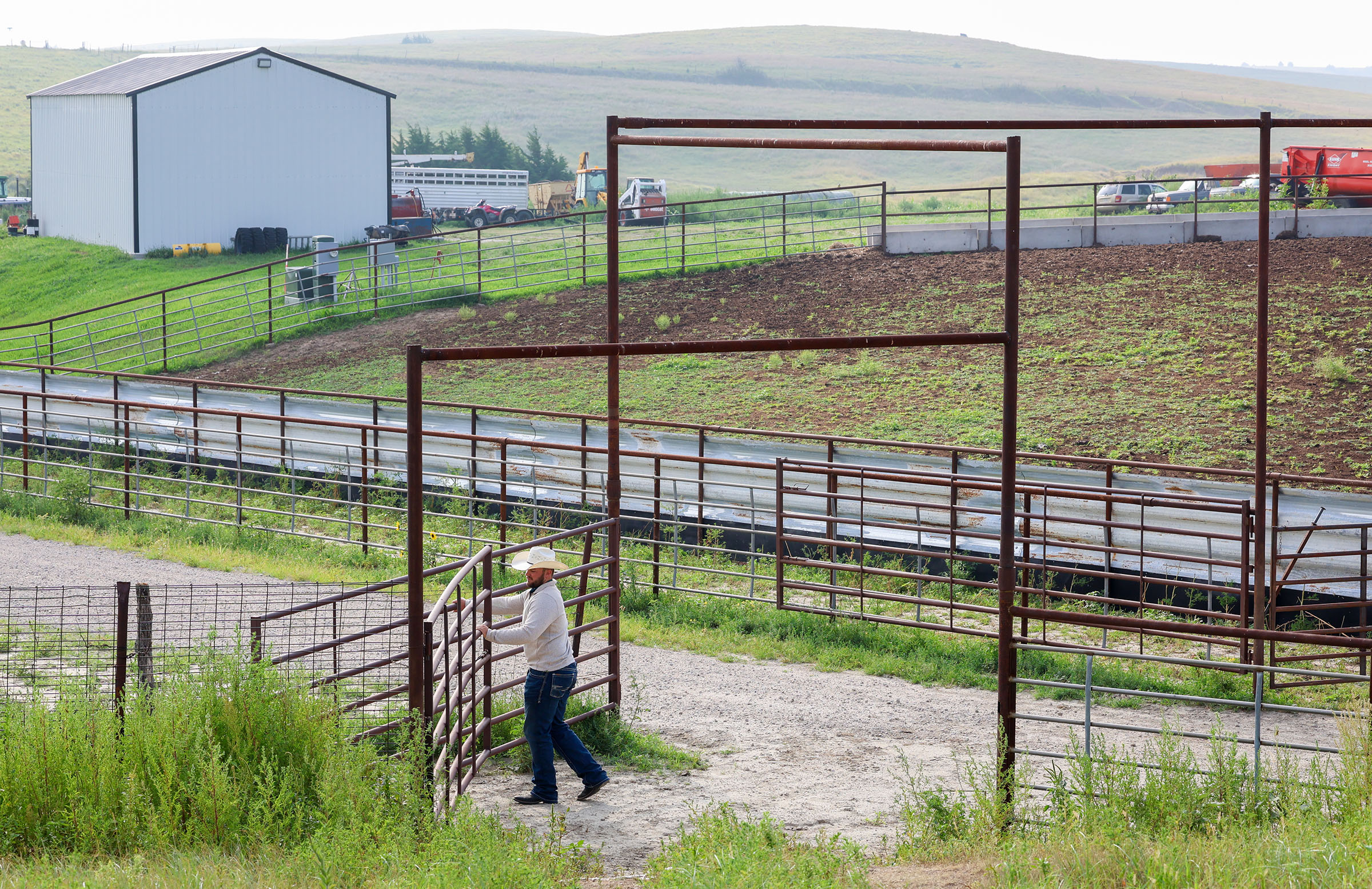 Ryan Arbuthnot opens a gate at the family ranch.