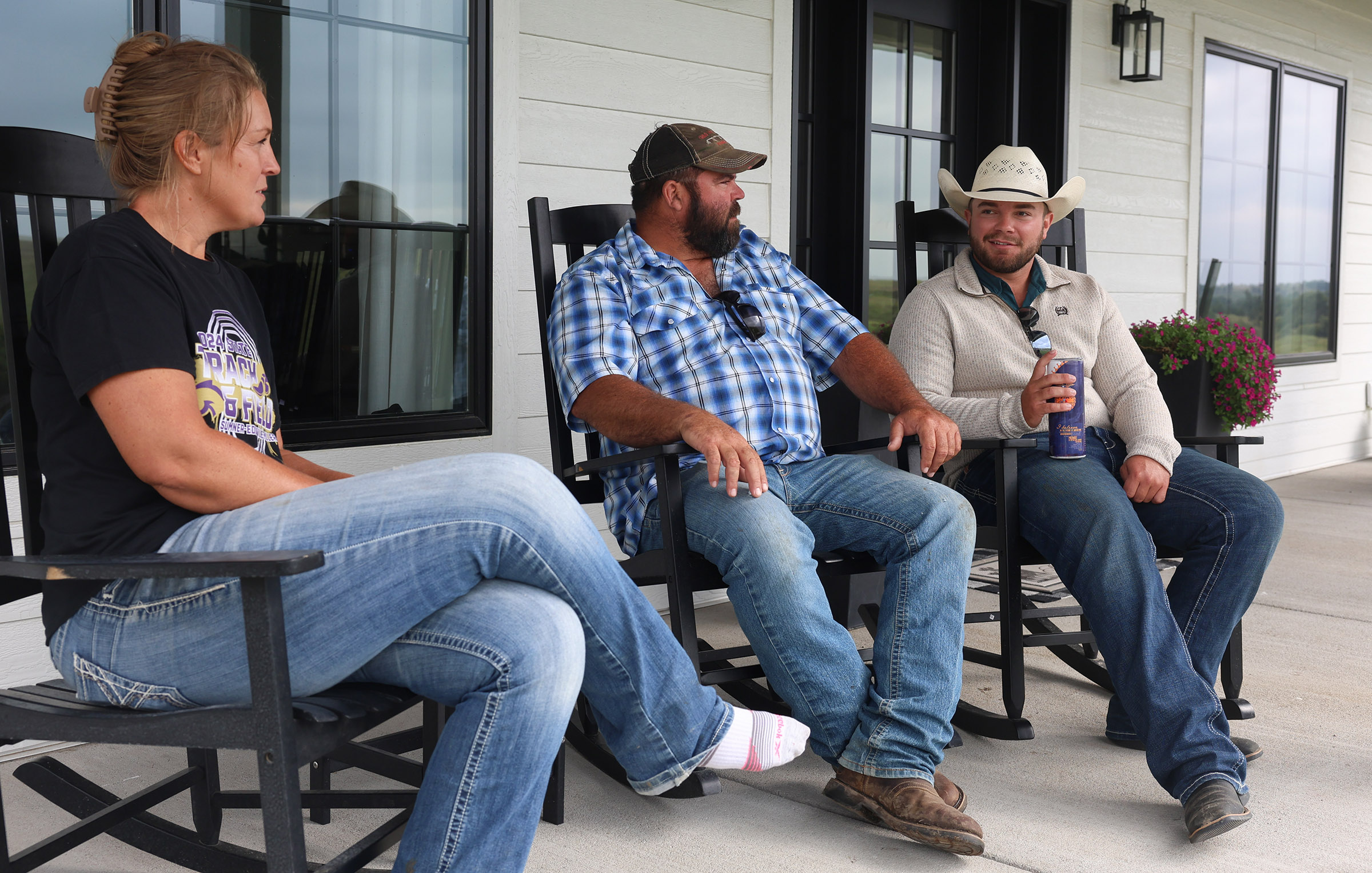 Ryan Arbuthnot chats with his parents on the front porch.