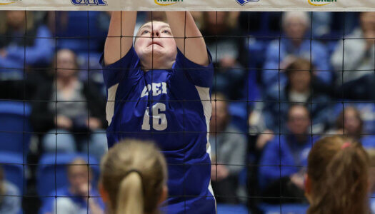 Sydney Davis attacks the ball at the net.