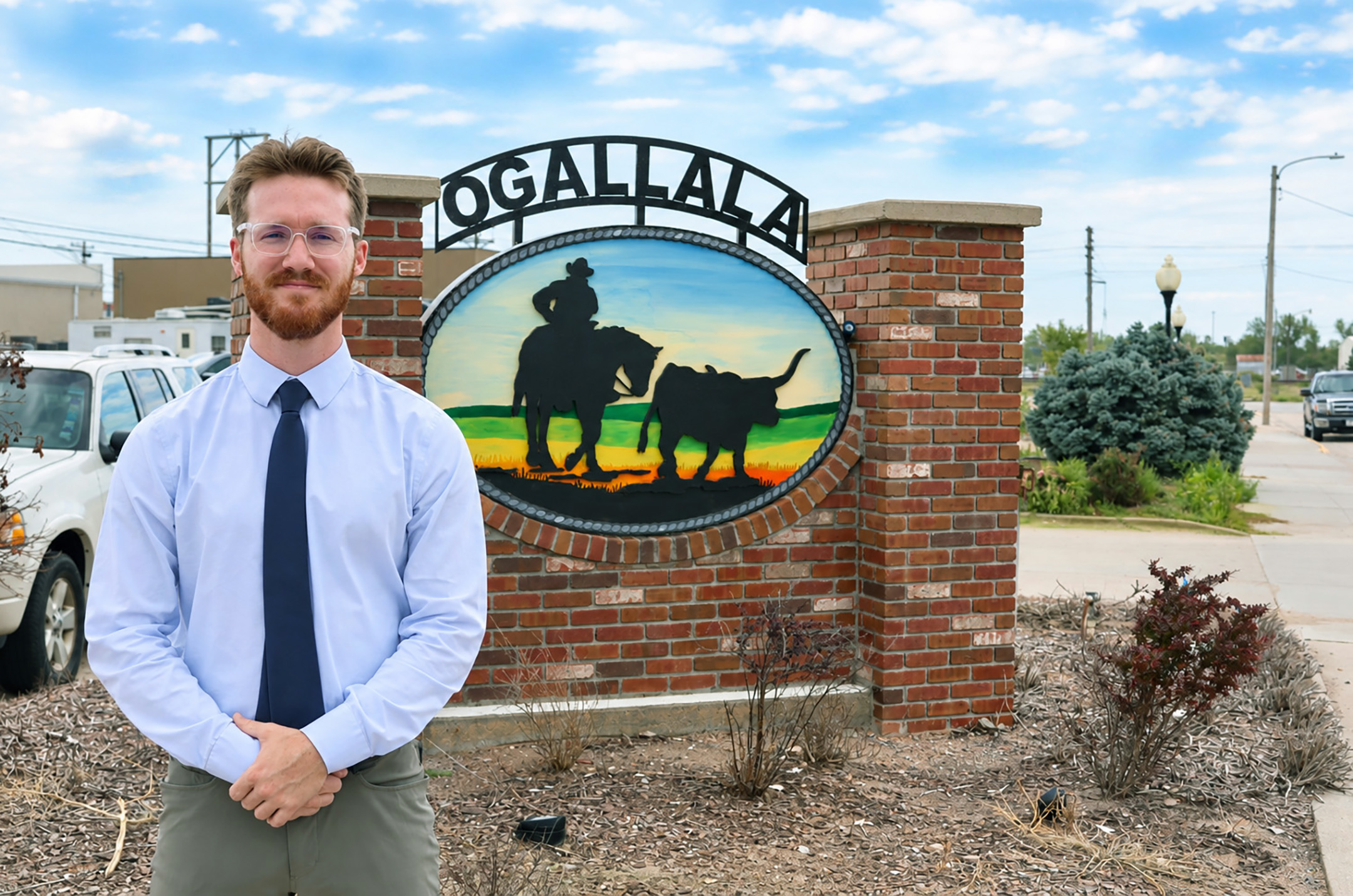 Tell Jensen poses for a photo in front of an Ogallala sign.