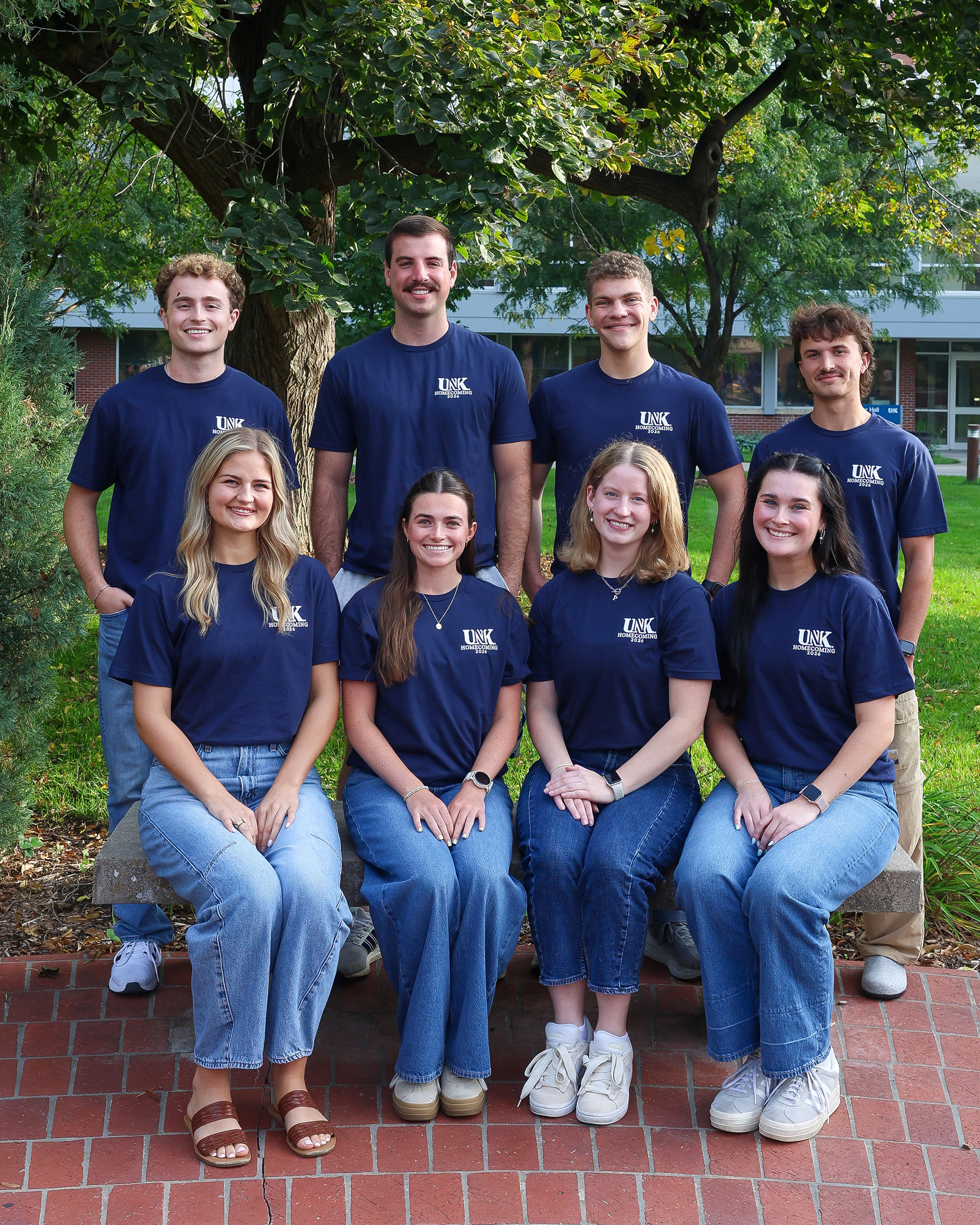 UNK homecoming royalty finalists pose for a photo on campus.