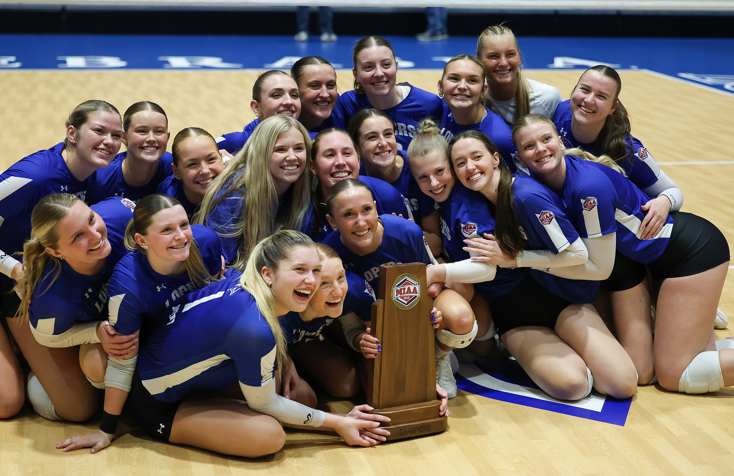 The UNK volleyball team celebrates after earning a share of the 2025 MIAA regular-season title.