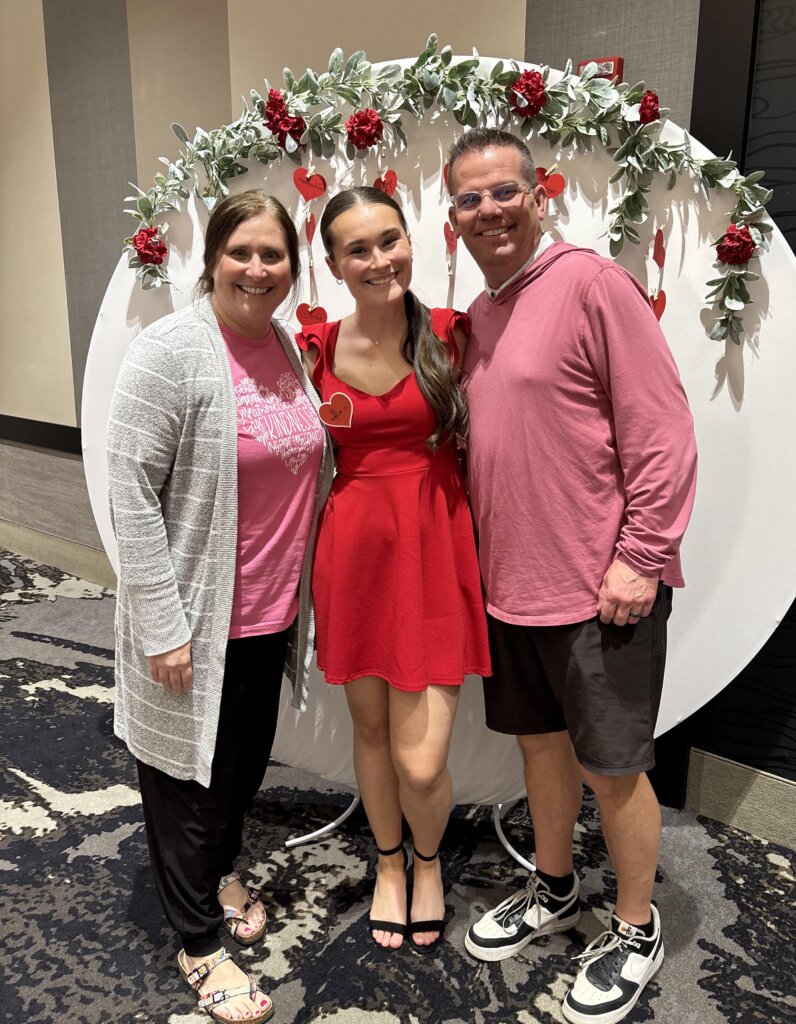 Addison Chapman is pictured with her parents during an Alpha Phi fundraiser.