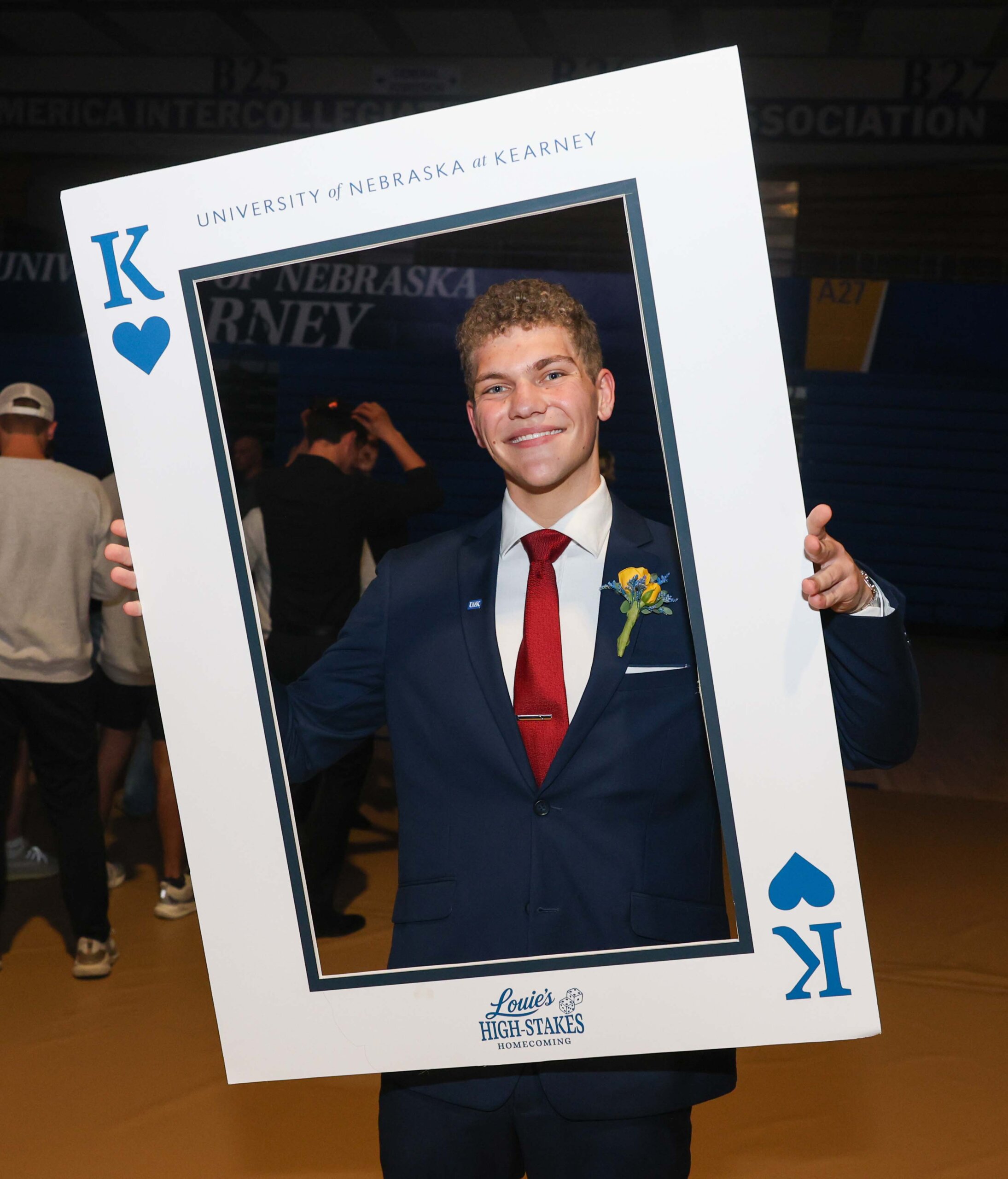 A student poses inside a playing card cutout.
