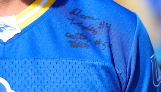 A closeup of Loper jersey that is signed by players.