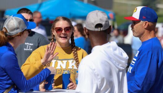 Loper Alumnae Heidi Knake waves at the tailgate.