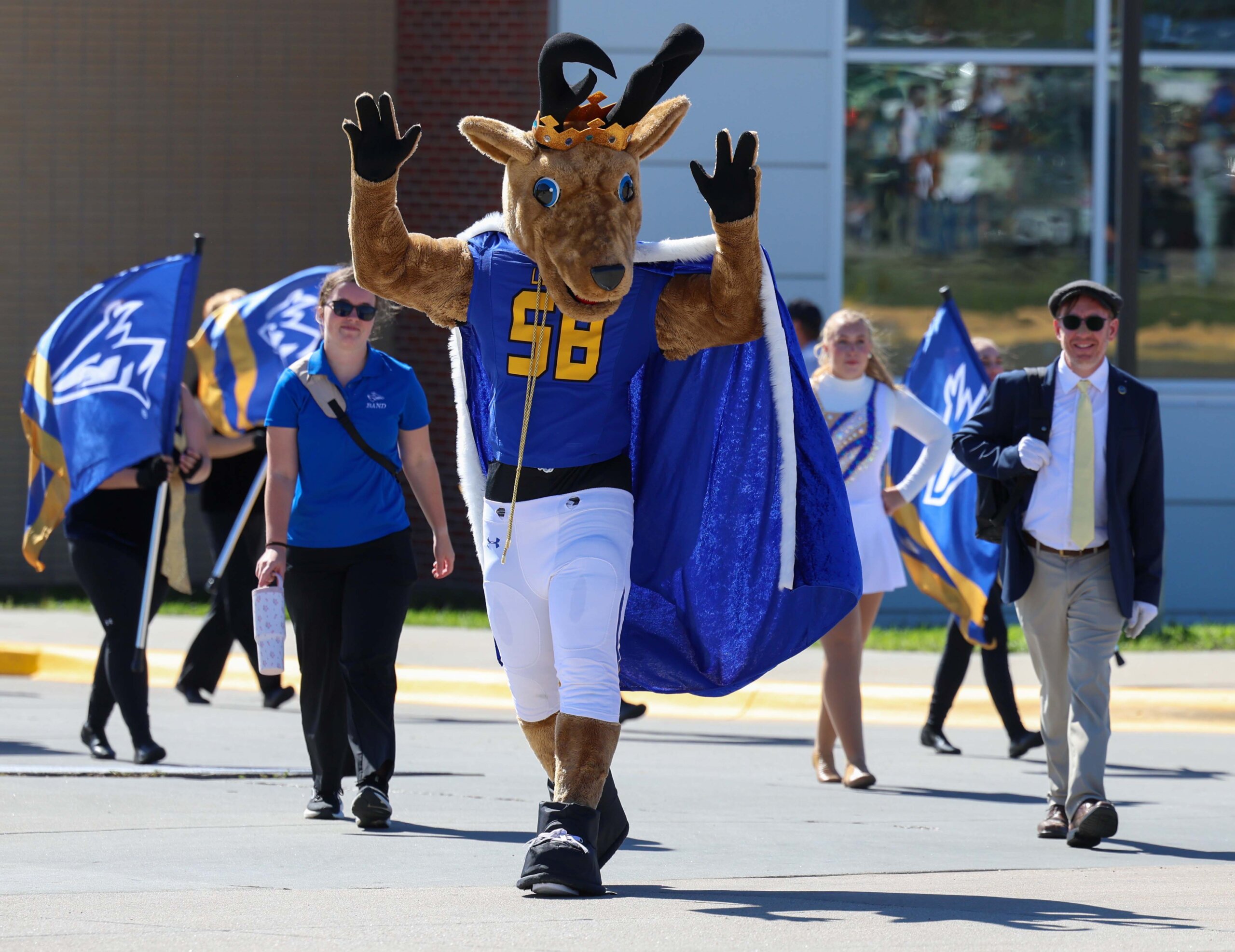 The UNK mascot waves at the crowd.