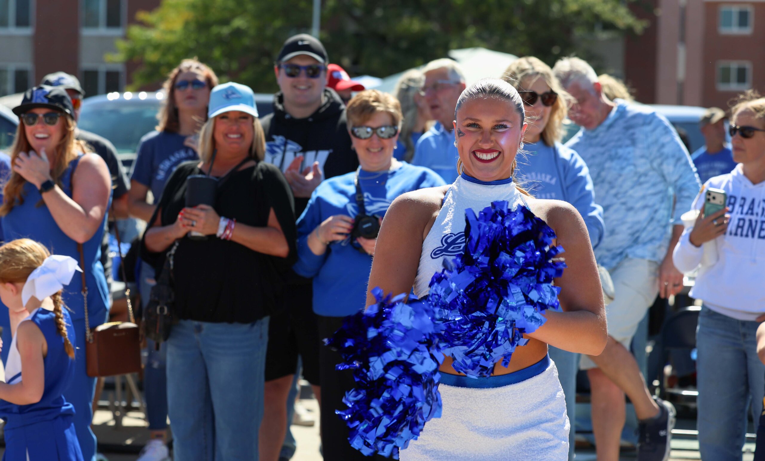 A dancer and her family smile at the camera.