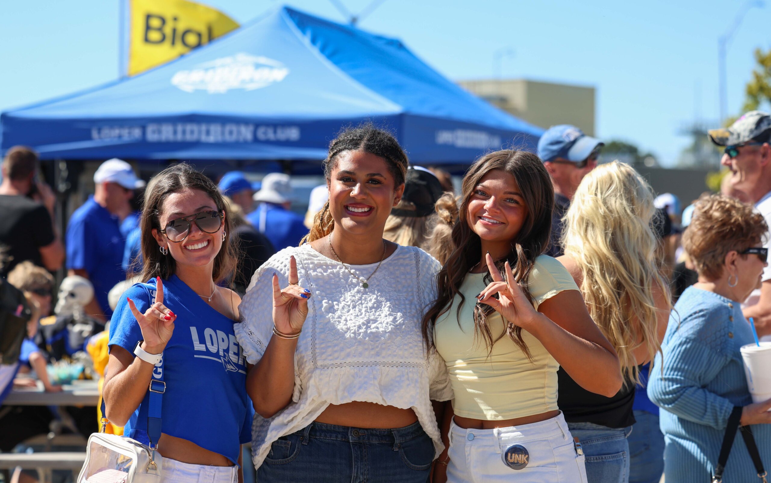 Students throw their Lopes at the tailgate.