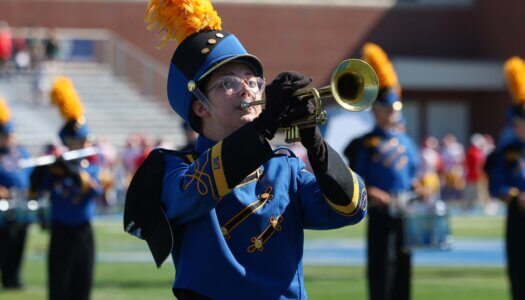 Student Abby Trantham plays the trumpet at the game.