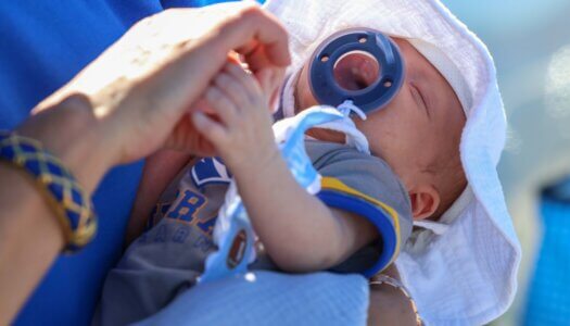 An infant is dressed in Loper gear.