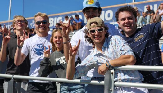 Students throw their Lopes at the football game.