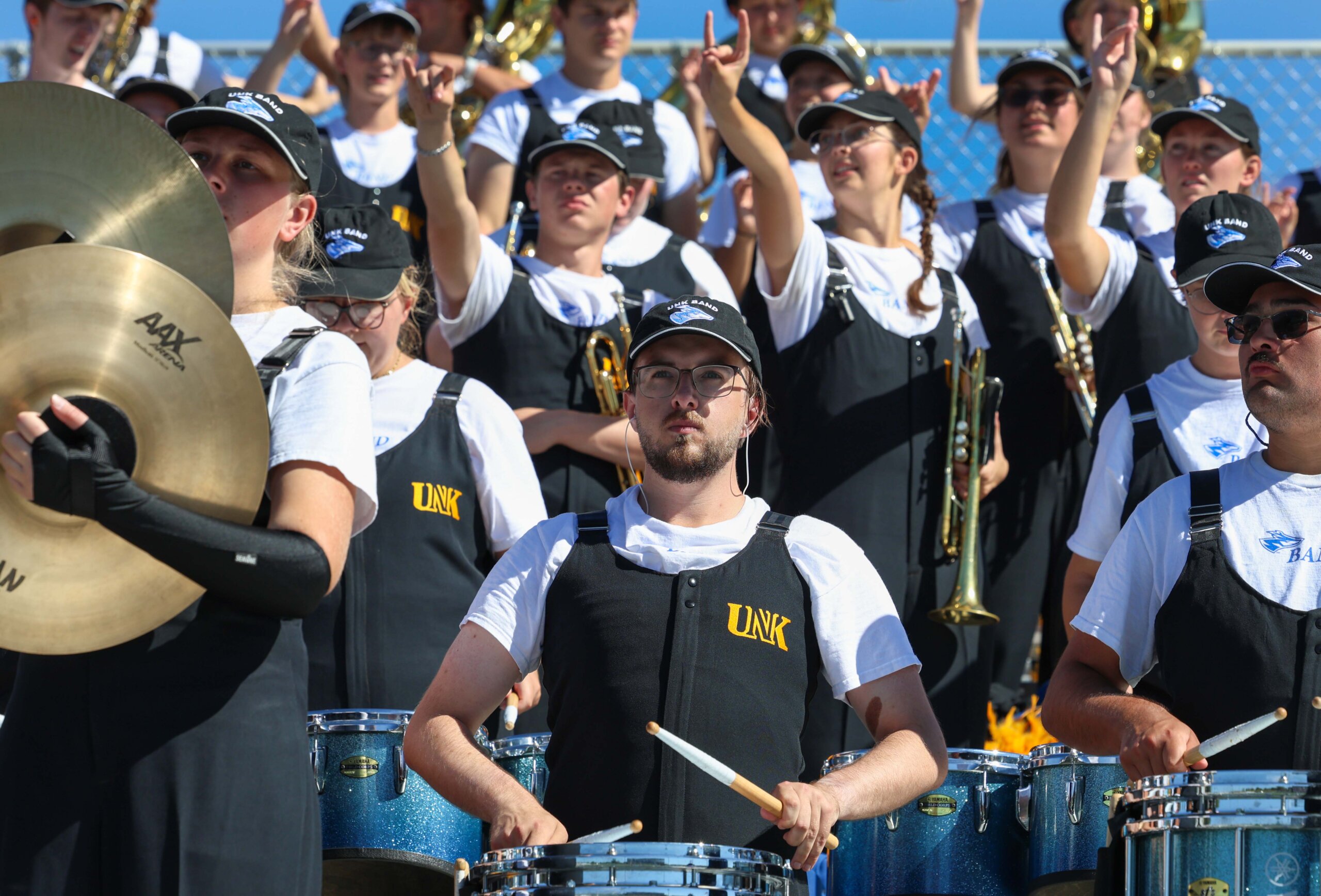 The Pride of the Plains Marching Band performs from the stands.