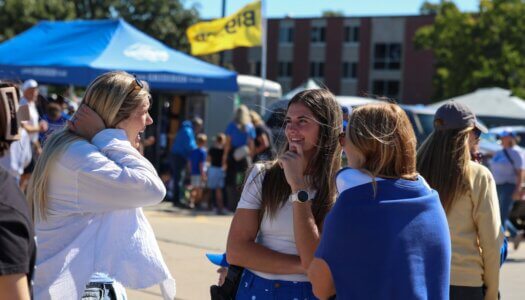 Loper alumni chat at the tailgate.