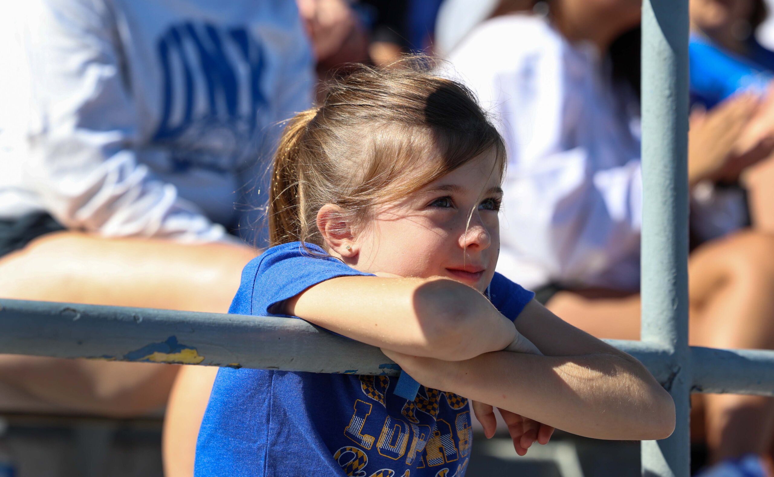 A child leans on a railing.