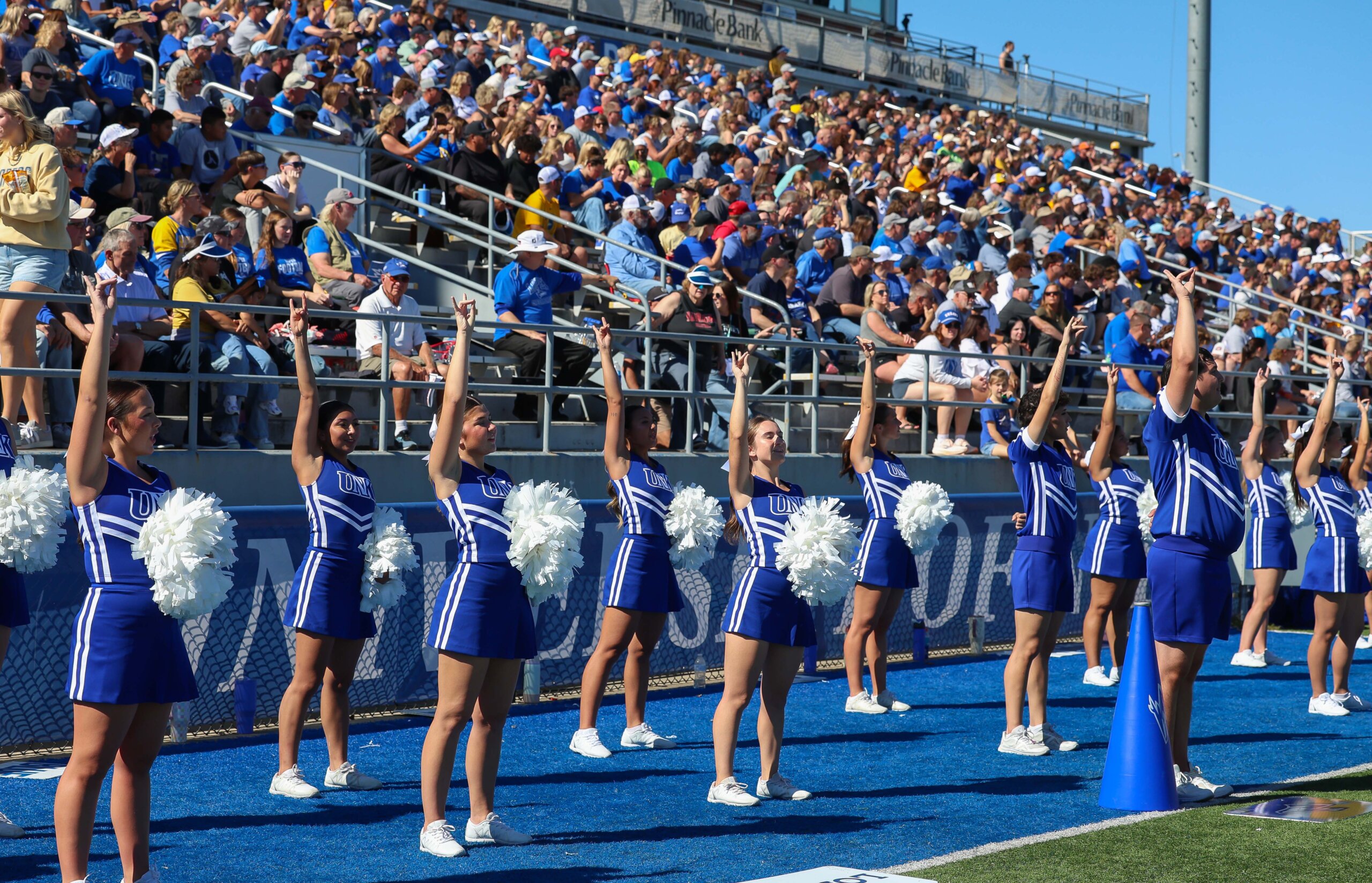 Cheerleaders throw their Lopes.