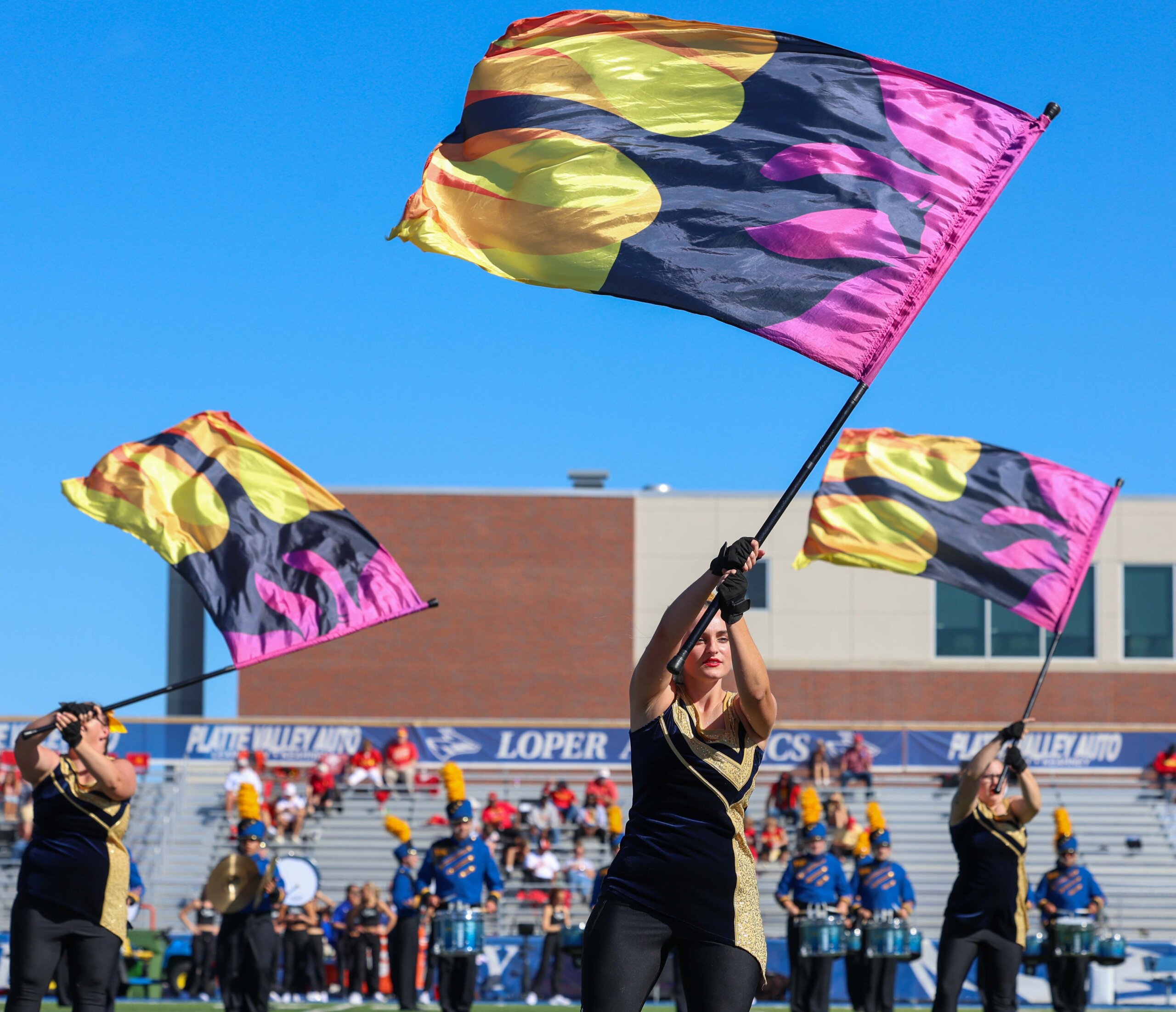 The flag corps performs at halftime.